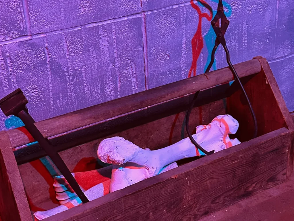 Haunted basement escape room filled with eerie relics, supernatural puzzles, and dark secrets