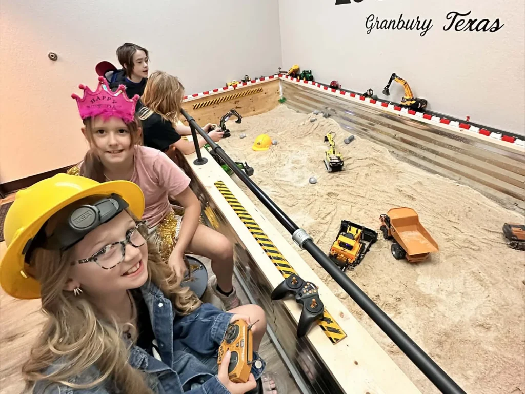 Children operating RC construction equipment in the Dig Zone